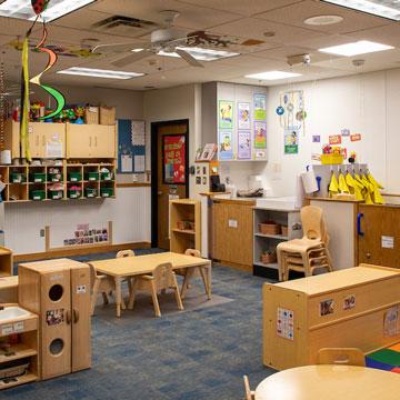 Toddler Classroom, showing the dramatic play area, music area, and child cubbies.